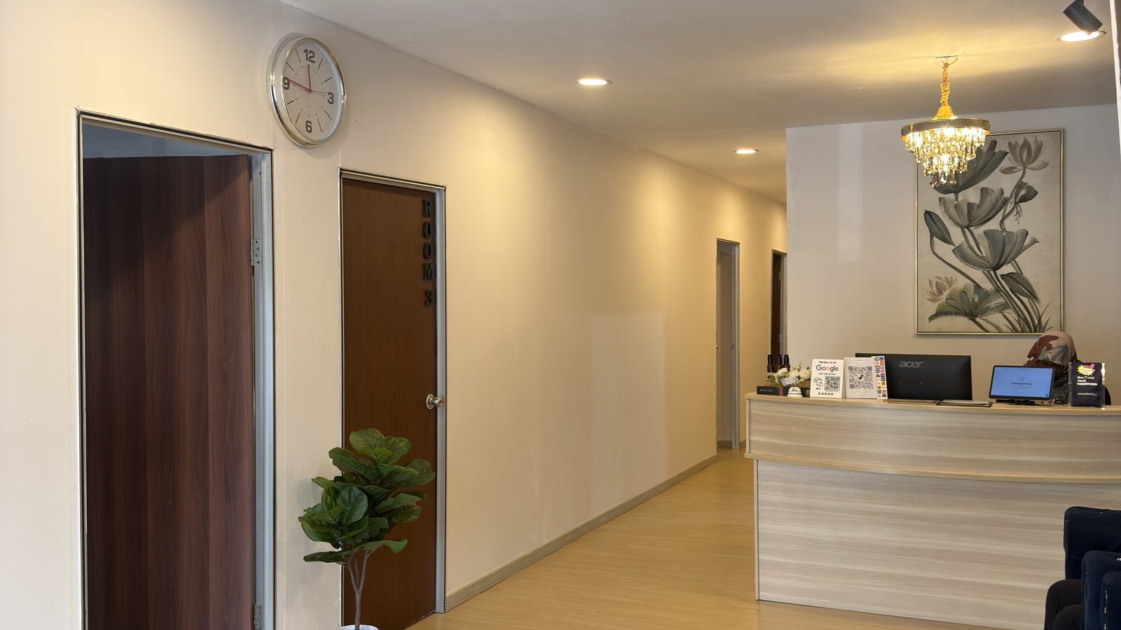 Lobby wide angle — reception and waiting area with warm lighting (IMG_1062, centre crop 16:9)